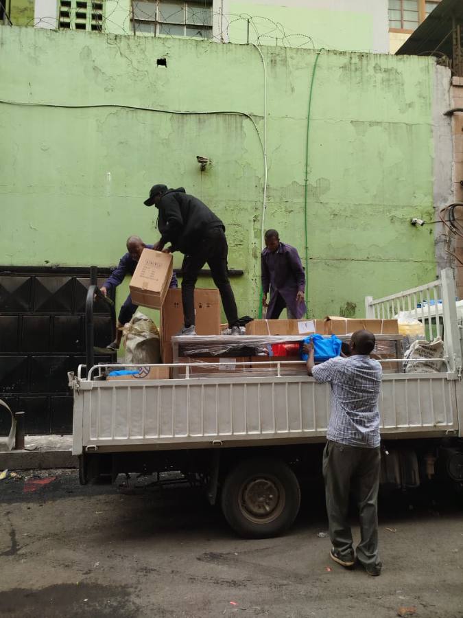 The team loading boxed equipment onto the truck