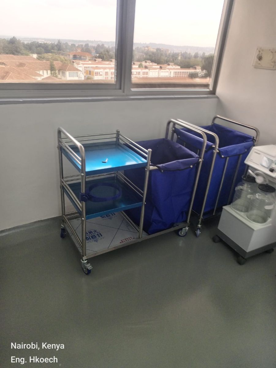 Instrument trolley, linen trolleys and suction unit in a hospital room