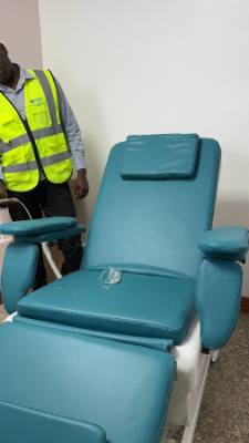 A Jodroc engineer beside a dialysis chair fitted in a clinic