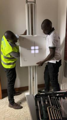 Two Jodroc engineers mounting a chest X-ray detector panel