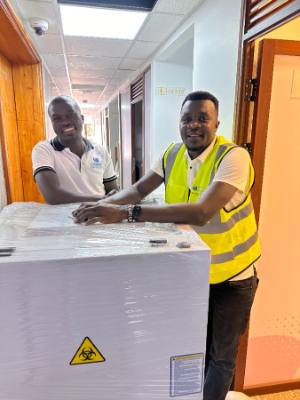 A Jodroc staff member with a crated biosafety cabinet on delivery day